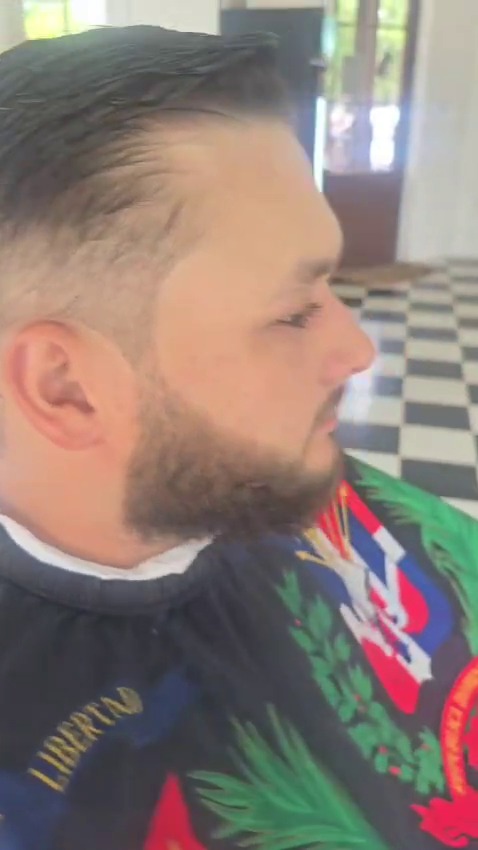 A client's full beard, shaped and edged along the cheek and jaw, in profile.