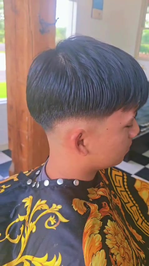 A client's finished signature fade in profile, blended from a close taper up into length on top.