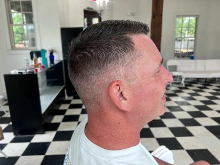 A client's high skin fade in profile, blended sharp above the ear.